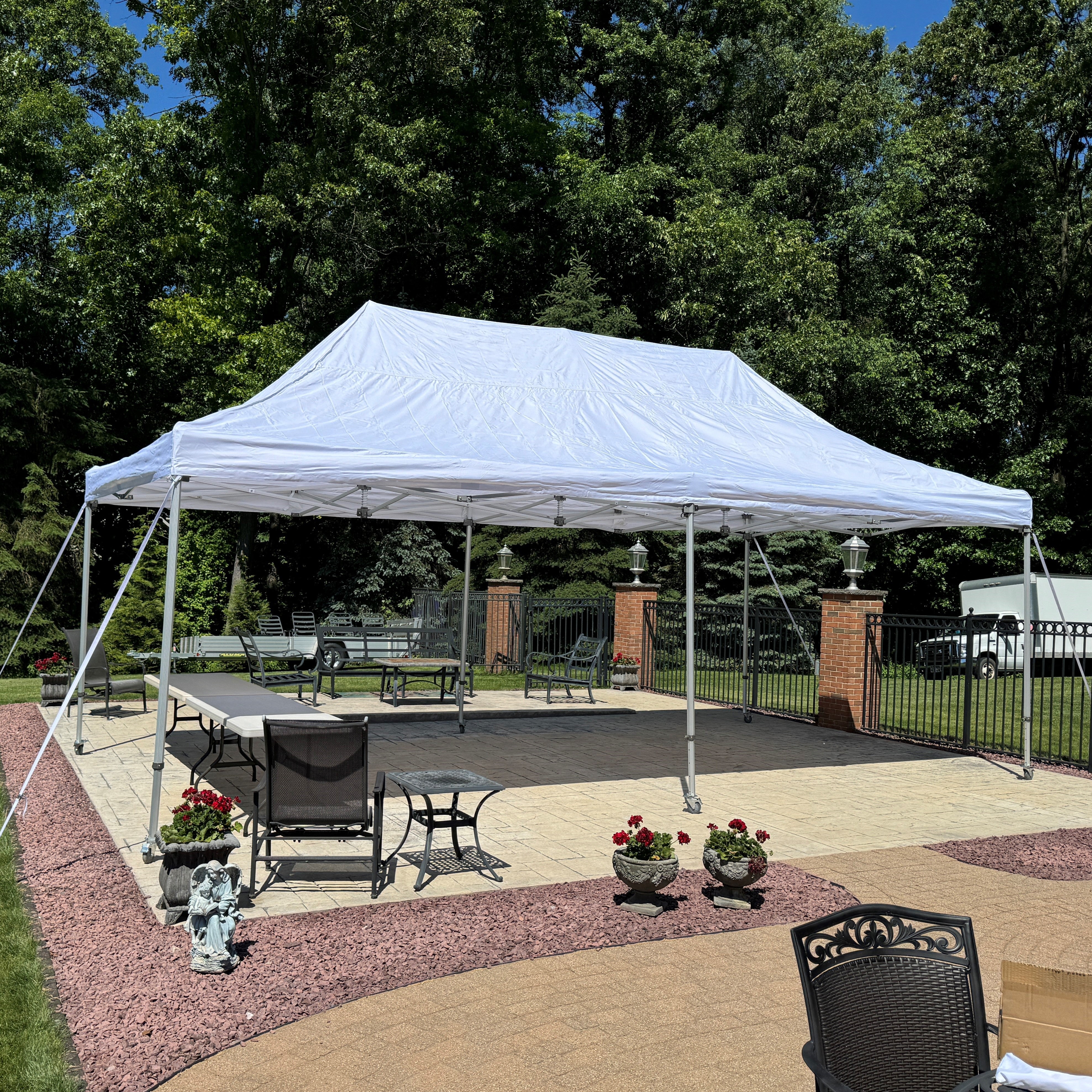 Large white pop-up canopy tent set up on a patio by Extreme Canopy