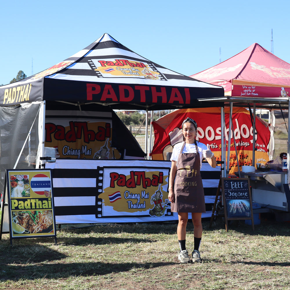canopy tent set up with custom-printed half wall featuring "Padthai" branding.