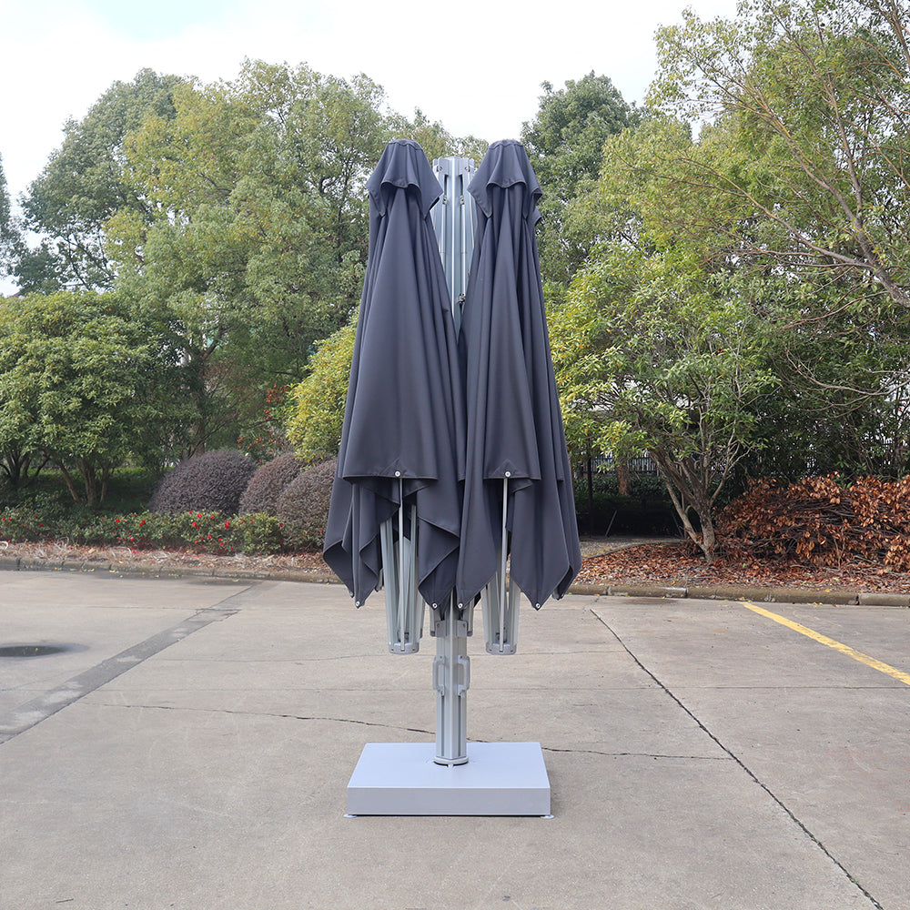 Multi-shade cantilever umbrella system shown in the closed position, with dark gray canopies folded around a central pole on a weighted base.