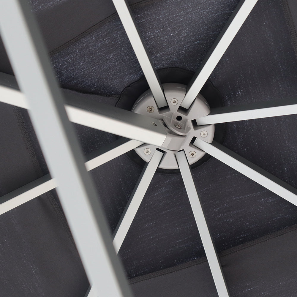 Multi-shade umbrella frame, showing the central hub and metal support arms beneath the canopy.