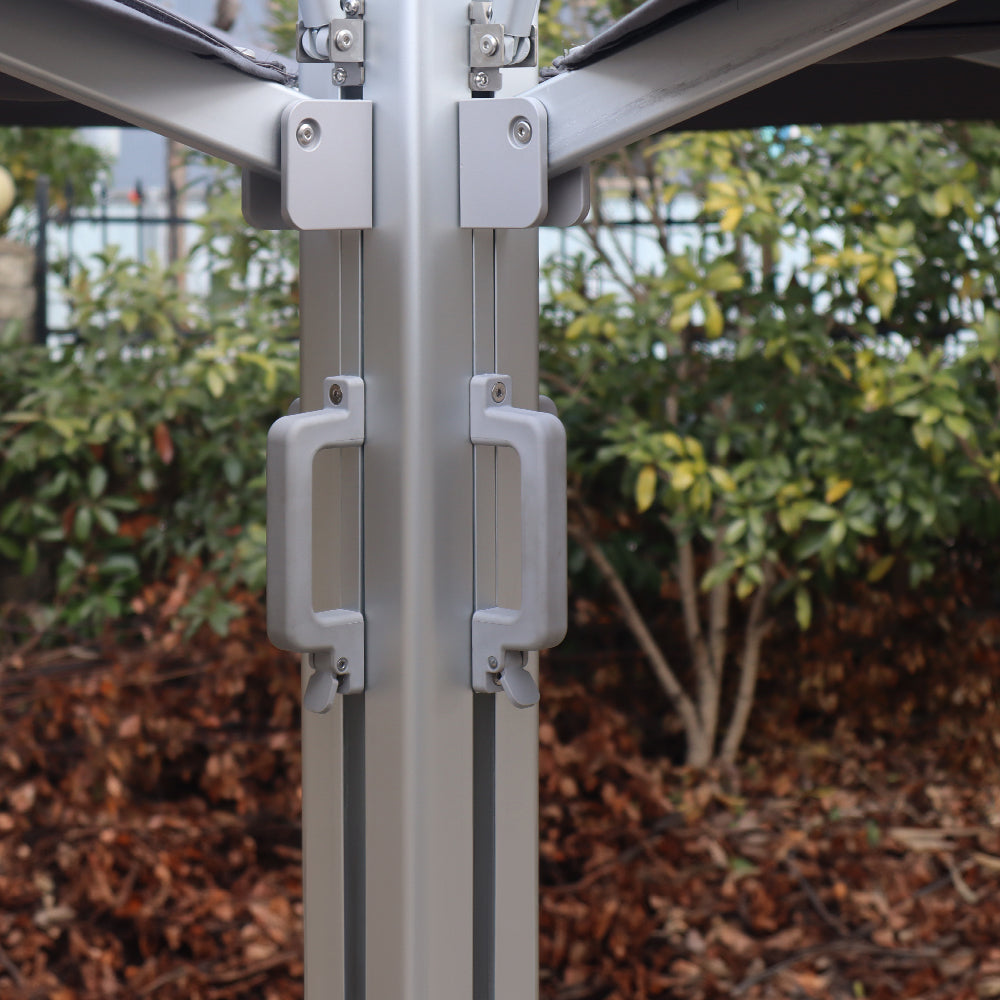 Multi-shade umbrella’s central pole showing the metal frame profile and dual sliding adjustment handles.