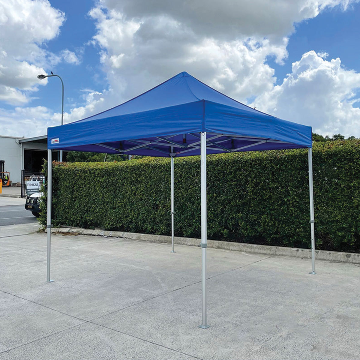 Blue 10x10 ft pop-up canopy tent with extended aluminum legs set up by Extreme Canopy